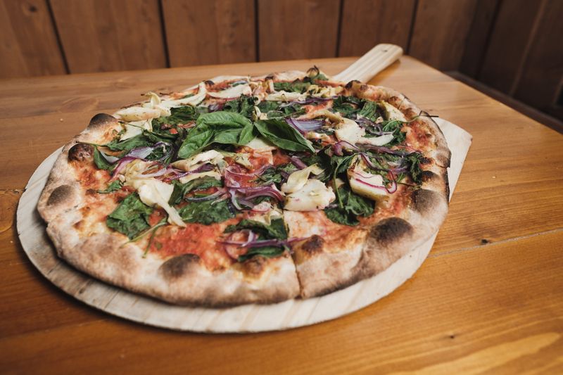 White pizza with garlic cream sauce and spinach artichoke