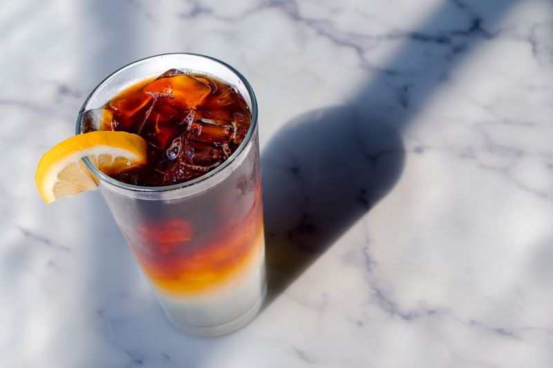 Iced tea with lemon served in tall glass